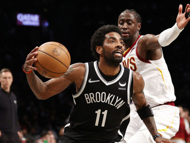 NEW YORK, NEW YORK - APRIL 12: Kyrie Irving #11 of the Brooklyn Nets dribbles as Caris LeVert #3 of the Cleveland Cavaliers defends during the first half of the Eastern Conference 2022 Play-In Tournament at Barclays Center on April 12, 2022 in the Brooklyn borough of New York City.