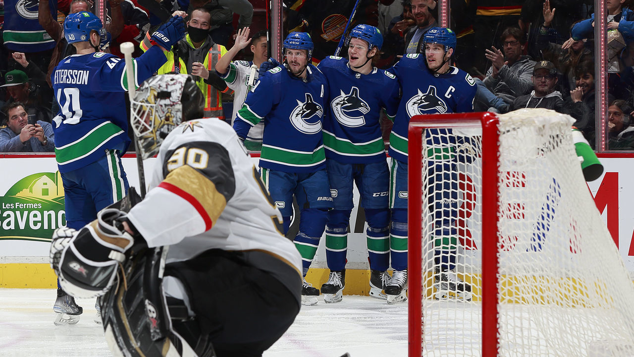 VANCOUVER, BC - APRIL 12: Vasily Podkolzin #92 of the Vancouver Canucks is congratulated by teammates after scoring on Robin Lehner #90 of the Vegas Golden Knights during their NHL game at Rogers Arena April 12, 2022 in Vancouver, British Columbia, Canada.