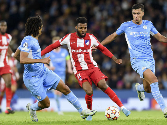 MANCHESTER, ENGLAND - APRIL 05: Nathan Ake of Manchester City and Thomas Lemar of Atletico de Madrid battle for the ball during the UEFA Champions League Quarter Final Leg One match between Manchester City and Atlético Madrid at City of Manchester Stadium on April 5, 2022 in Manchester, United Kingdom.