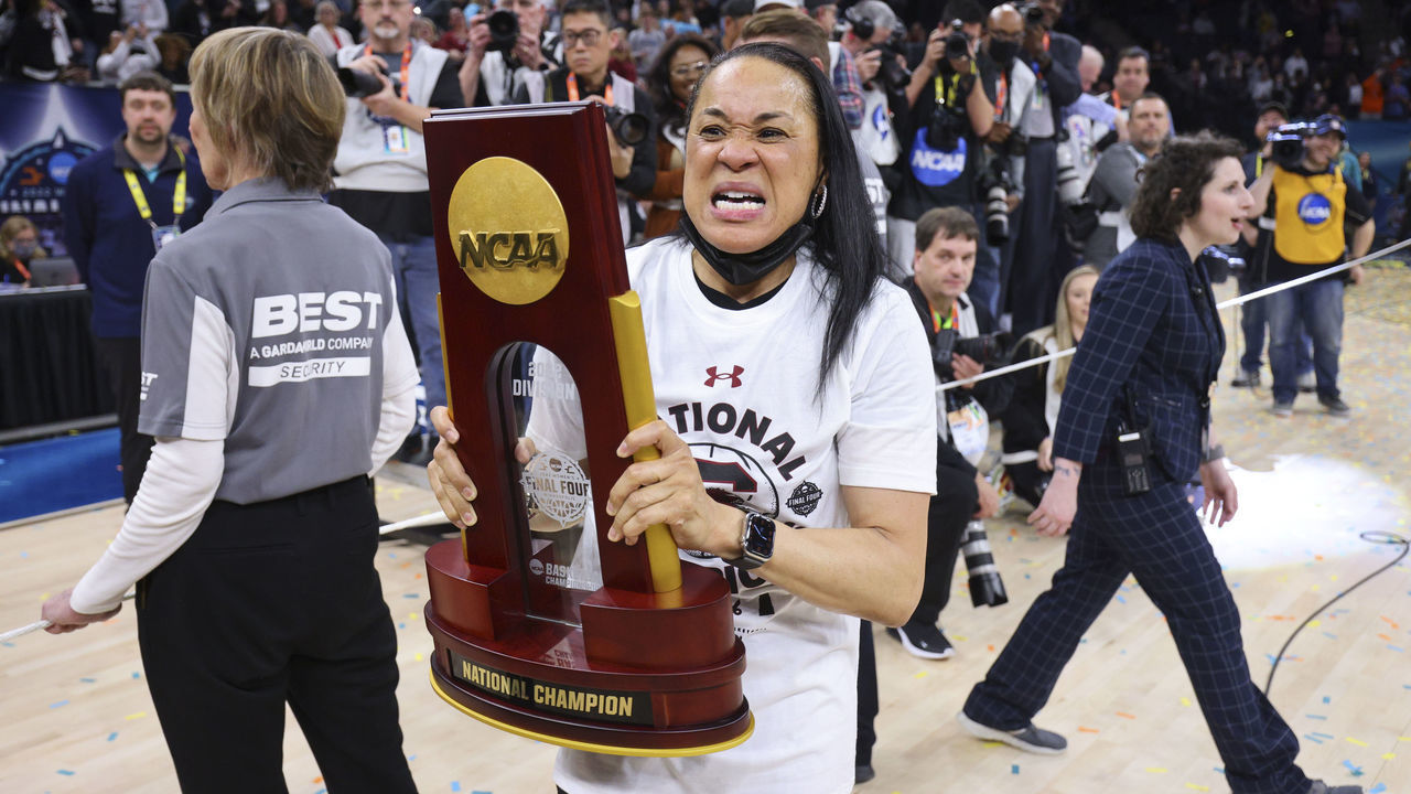 MINNEAPOLIS, MN - APRIL 03: Head coach Dawn Staley of the South Carolina Gamecocks celebrates with the national champion trophy after defeating the UConn Huskies during the championship game of the NCAA Women’s Basketball Tournament at Target Center on April 3, 2022 in Minneapolis, Minnesota.