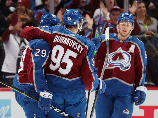 DENVER, COLORADO - APRIL 13: Andre Burakovsky #95 and Nathan MacKinnon #29 of the Colorado Avalanche celebrate a goal by Burakovsky against the Los Angeles Kings at Ball Arena on April 13, 2022 in Denver, Colorado.