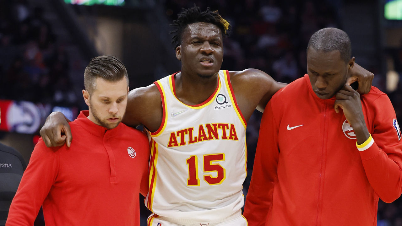 CLEVELAND, OHIO - APRIL 15: Clint Capela #15 of the Atlanta Hawks is helped off the court after he is injured in the first half against the Cleveland Cavaliersat Rocket Mortgage Fieldhouse on April 15, 2022 in Cleveland, Ohio.