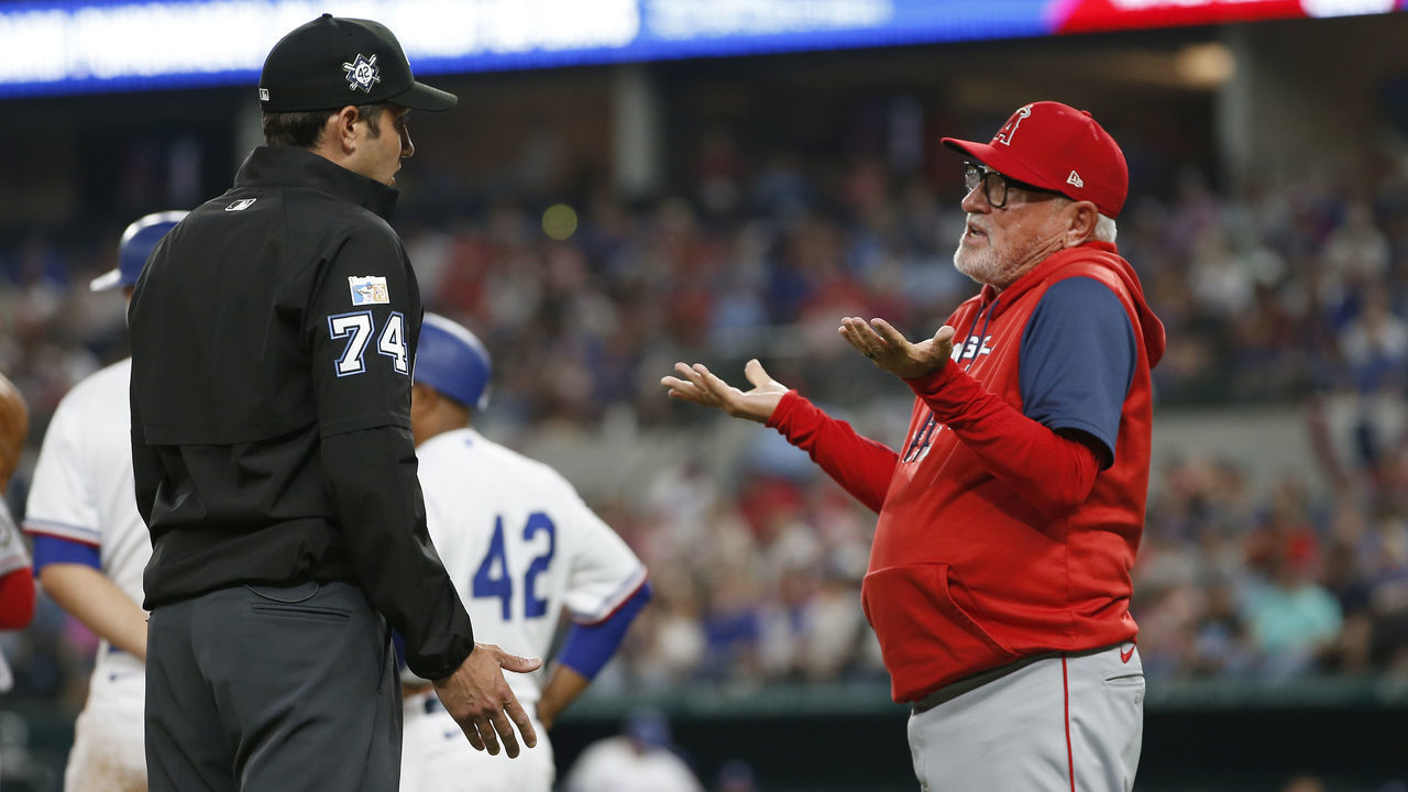 ARLINGTON, TEXAS - APRIL 15: Joe Maddon #70 of the Los Angeles Angels talks to umpire John Tumpane #74 after a balk was called in the fourth inning of the game against the Texas Rangers at Globe Life Field on April 15, 2022 in Arlington, Texas. All players are wearing the number 42 in honor of Jackie Robinson Day.