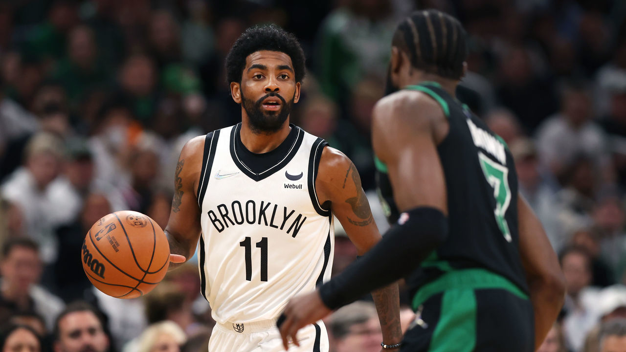 BOSTON, MASSACHUSETTS - APRIL 17: Kyrie Irving #11 of the Brooklyn Nets dribbles downcourt against Jaylen Brown #7 of the Boston Celtics during the first quarter of Round 1 Game 1 of the 2022 NBA Eastern Conference Playoffs at TD Garden on April 17, 2022 in Boston, Massachusetts.