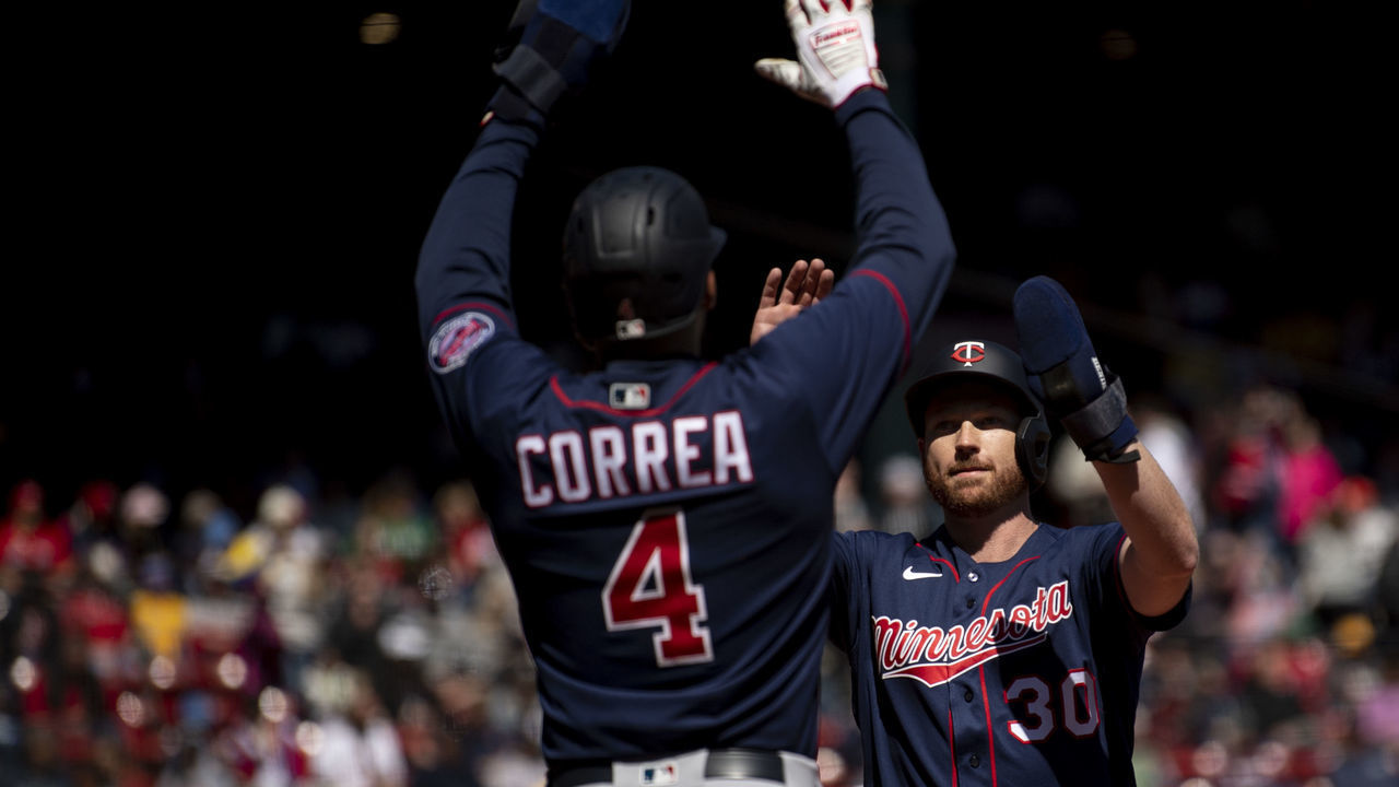 BOSTON, MA - APRIL 18: Kyle Garlick #30 of the Minnesota Twins reacts with Carlos Correa #4 of the Minnesota Twins after hitting a two-run home run during the first inning of a game against the Minnesota Twins on April 18, 2022 at Fenway Park in Boston, Massachusetts.