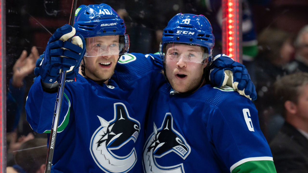 VANCOUVER, BC - APRIL 18: Vancouver Canucks right wing Brock Boeser (6) is congratulated by center Elias Pettersson (40) after scoring a goal against the Dallas Stars during their NHL game at Rogers Arena on April 18, 2022 in Vancouver, British Columbia, Canada.