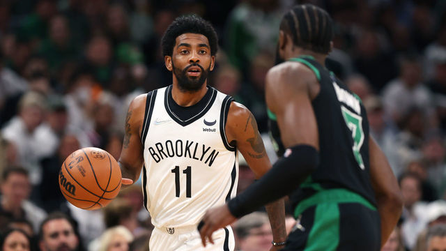 BOSTON, MASSACHUSETTS - APRIL 17: Kyrie Irving #11 of the Brooklyn Nets dribbles downcourt against Jaylen Brown #7 of the Boston Celtics during the first quarter of Round 1 Game 1 of the 2022 NBA Eastern Conference Playoffs at TD Garden on April 17, 2022 in Boston, Massachusetts.