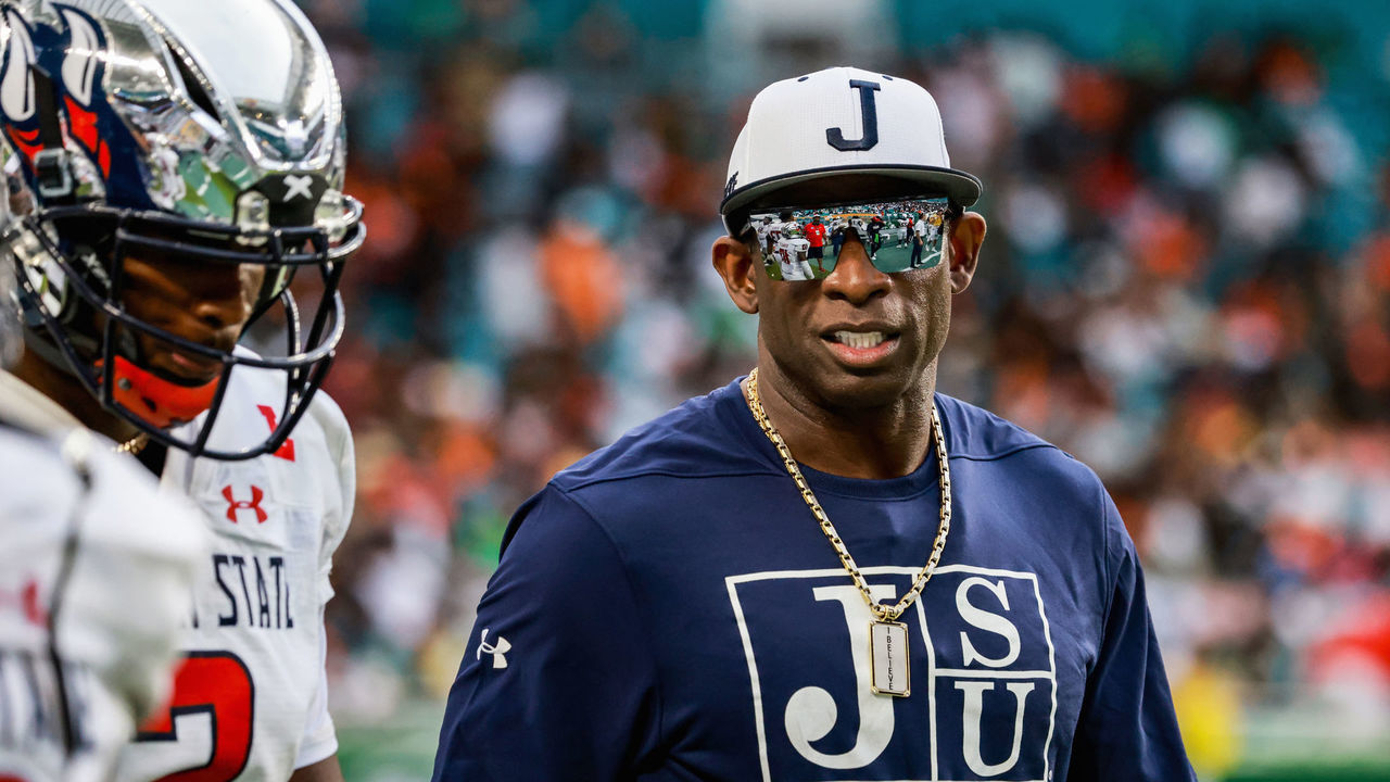 Coach Deion Prime Sanders talks with his son, Shedeur Sanders, Jackson State University Quarterback before the start of the second half of the game against Florida A&M University at Hard Rock Stadium on September 5th, 2021 in Miami Gardens, Florida.