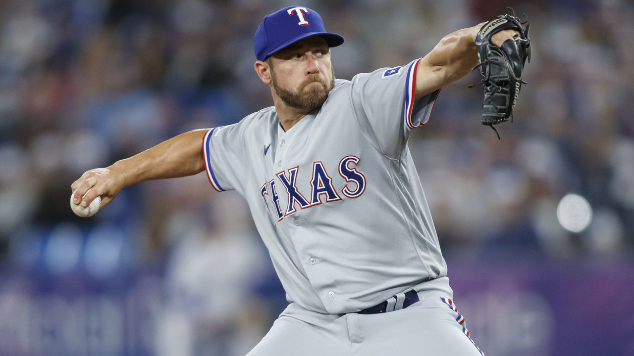 TORONTO, ON - APRIL 08: Greg Holland #40 of the Texas Rangers pitches in the eighth inning of their MLB game against the Toronto Blue Jays on Opening Day at Rogers Centre on April 8, 2022 in Toronto, Canada.