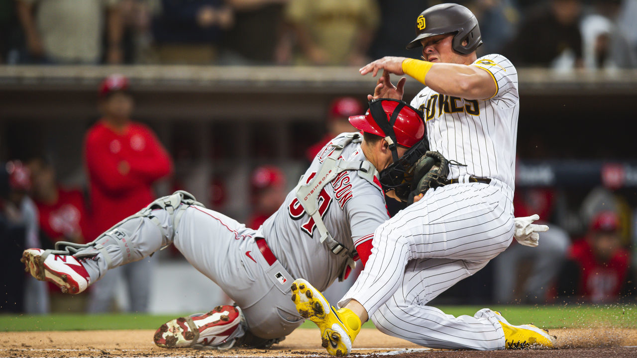SAN DIEGO, CA - APRIL 19: Luke Voit #45 of the San Diego Padres crashes into Tyler Stephenson #37 of the Cincinnati Reds in the first inning at Petco Park on April 19, 2022 in San Diego, California.
