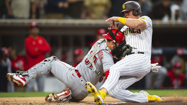 SAN DIEGO, CA - APRIL 19: Luke Voit #45 of the San Diego Padres crashes into Tyler Stephenson #37 of the Cincinnati Reds in the first inning at Petco Park on April 19, 2022 in San Diego, California.