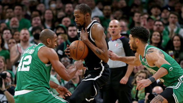 BOSTON, MA - April 20: Jayson Tatum #0 and Al Horford #42 of the Boston Celtics gang up on Kevin Durant #7 of the Brooklyn Nets during the second half of Round 1 Game 2 of the 2022 NBA Playoffs at the TD Garden on April 20, 2022 in Boston, Massachusetts.