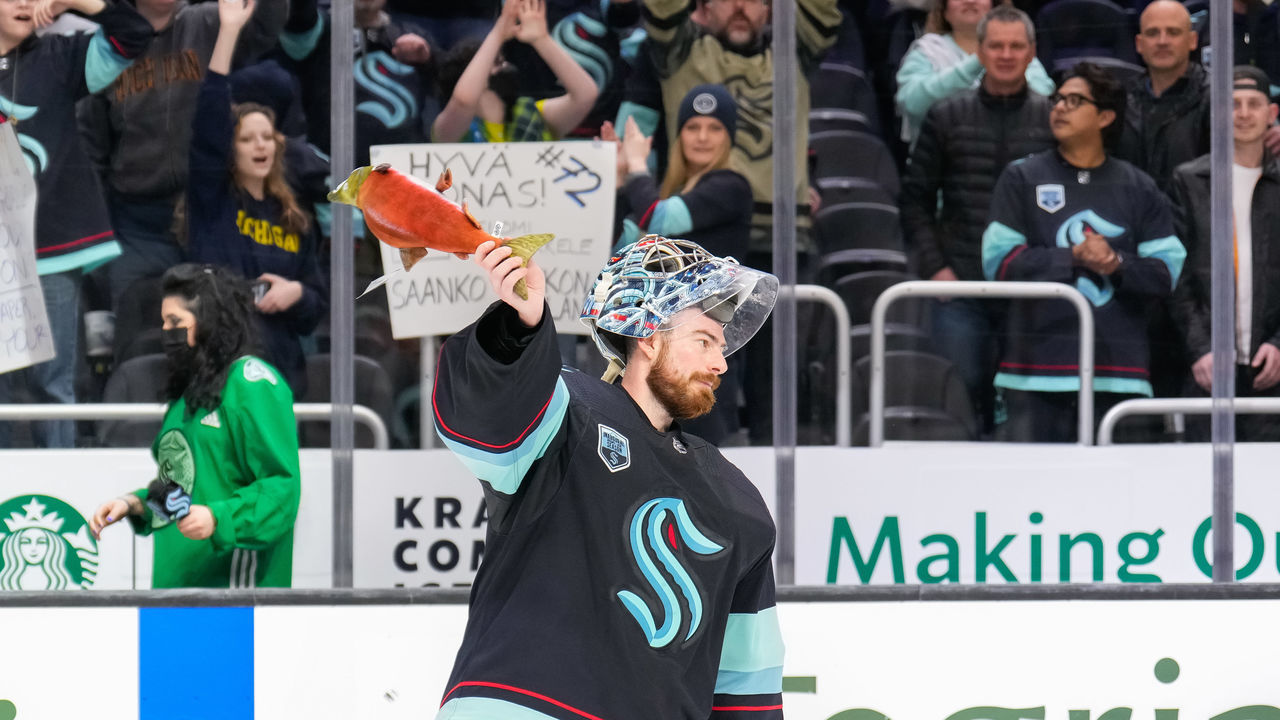 SEATTLE, WASHINGTON - APRIL 20: Philipp Grubauer #31 of the Seattle Kraken participates in the salmon toss after being named First Star of the Game during the 3-2 win against the Colorado Avalanche at Climate Pledge Arena on April 20, 2022 in Seattle, Washington.
