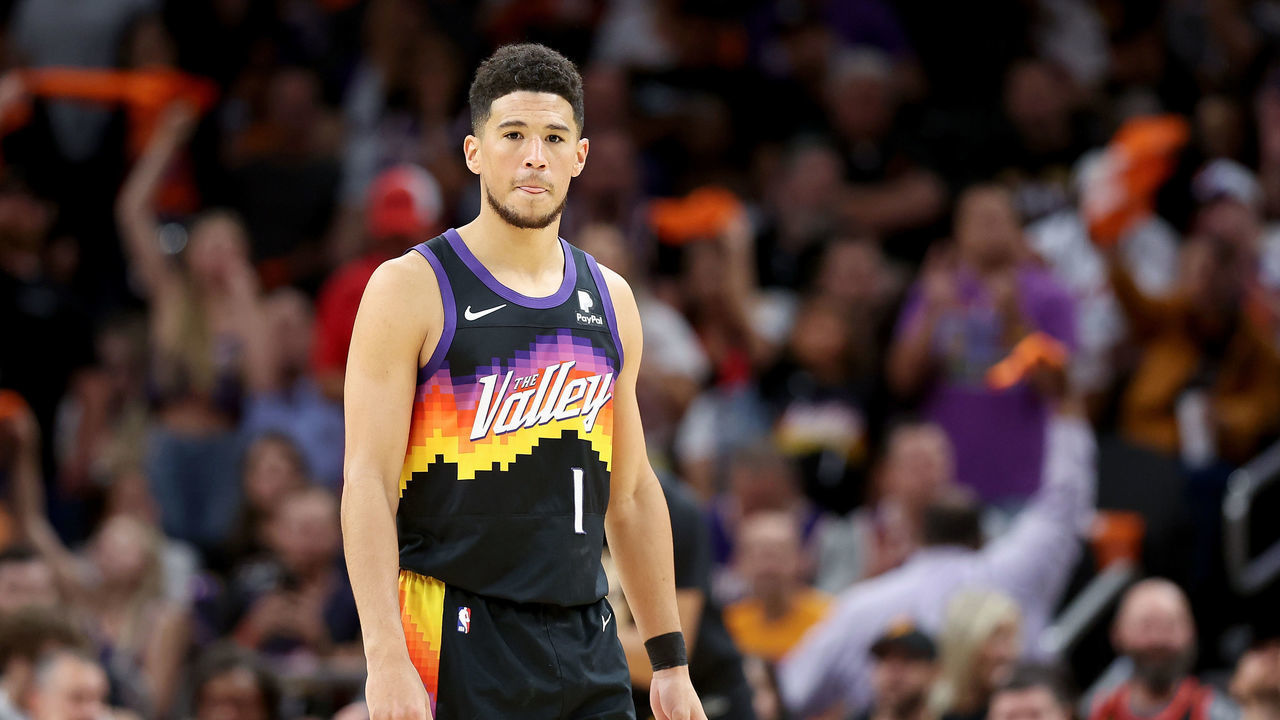 PHOENIX, ARIZONA - APRIL 19: Devin Booker #1 of the Phoenix Suns looks on during the first half of Game Two of the Western Conference First Round NBA Playoffs at Footprint Center on April 19, 2022 in Phoenix, Arizona.
