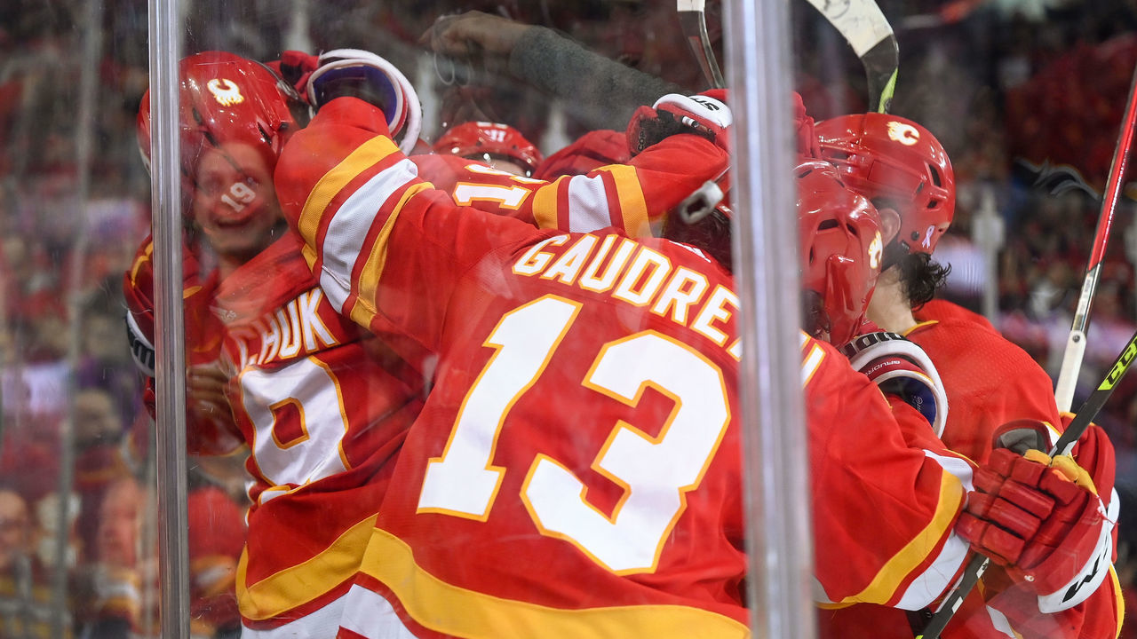 CALGARY, AB - APRIL 21: Calgary Flames Right Wing Matthew Tkachuk (19) celebrates with Calgary Flames Left Wing Andrew Mangiapane (88), Calgary Flames Center Elias Lindholm (28) and Calgary Flames Left Wing Johnny Gaudreau (13) after scoring his 100th point of the season during the second period of an NHL game where the Calgary Flames hosted the Dallas Stars on April 21, 2022, at the Scotiabank Saddledome in Calgary, AB.