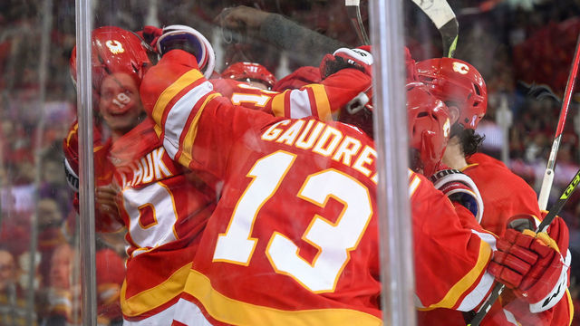 CALGARY, AB - APRIL 21: Calgary Flames Right Wing Matthew Tkachuk (19) celebrates with Calgary Flames Left Wing Andrew Mangiapane (88), Calgary Flames Center Elias Lindholm (28) and Calgary Flames Left Wing Johnny Gaudreau (13) after scoring his 100th point of the season during the second period of an NHL game where the Calgary Flames hosted the Dallas Stars on April 21, 2022, at the Scotiabank Saddledome in Calgary, AB.