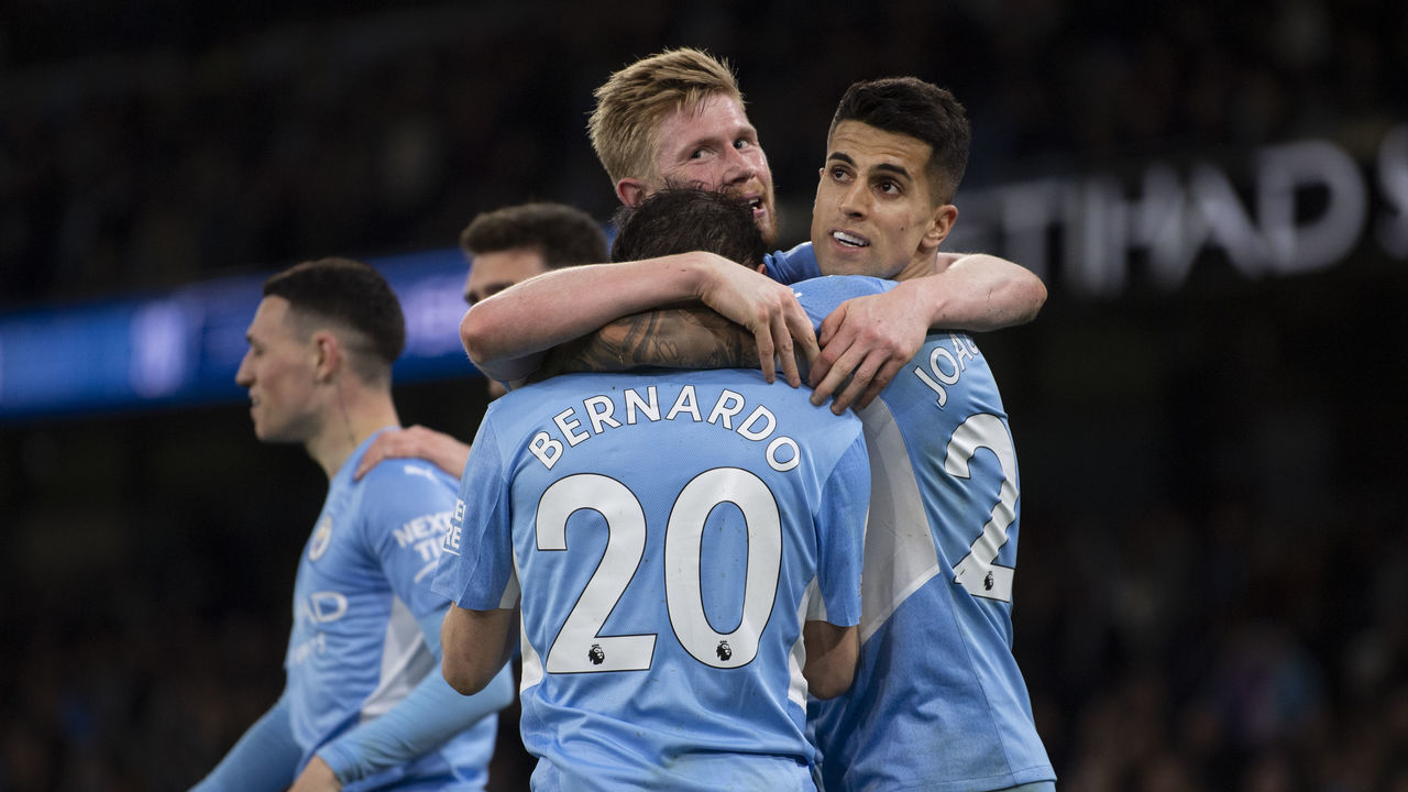 MANCHESTER, ENGLAND - APRIL 20: Bernardo Silva of Manchester City celebrates scoring the third goal with team mates Kevin De Bruyne and Joao Cancelo during the Premier League match between Manchester City and Brighton & Hove Albion at Etihad Stadium on April 20, 2022 in Manchester, United Kingdom.