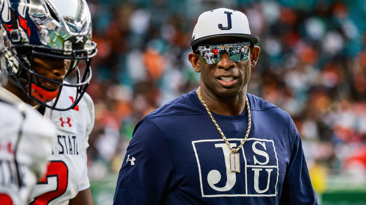 Coach Deion Prime Sanders talks with his son, Shedeur Sanders, Jackson State University Quarterback before the start of the second half of the game against Florida A&M University at Hard Rock Stadium on September 5th, 2021 in Miami Gardens, Florida.