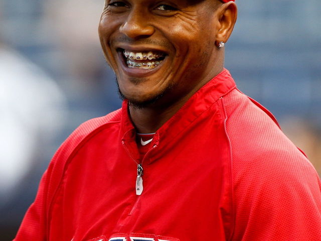 GIF: Erick Aybar avoids possible collision by hurdling into stands