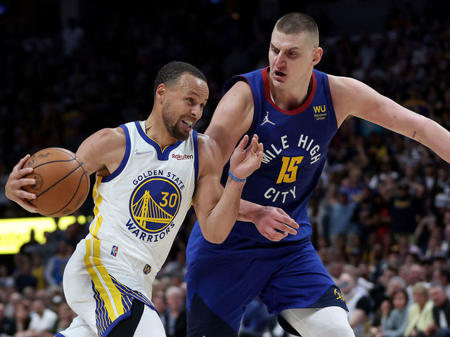 DENVER, COLORADO - APRIL 21: Stephen Curry #30 of the Golden State Warriors drives against Nikola Jokic #15 of the Denver Nuggets in the fourth quarter during Game Three of the Western Conference First Round NBA Playoffs at Ball Arena on April 21, 2022 in Denver, Colorado. NOTE TO USER: User expressly acknowledges and agrees that, by downloading and/or using this photograph, User is consenting to the terms and conditions of the Getty Images License Agreement.