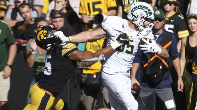 IOWA CITY, IOWA- SEPTEMBER 25: Tight end Trey McBride #85 of the Colorado State Rams fights off a tackle during the first half by linebacker Jestin Jacobs #5 of the Iowa Hawkeyes at Kinnick Stadium on September 25, 2021 in Iowa City, Iowa.