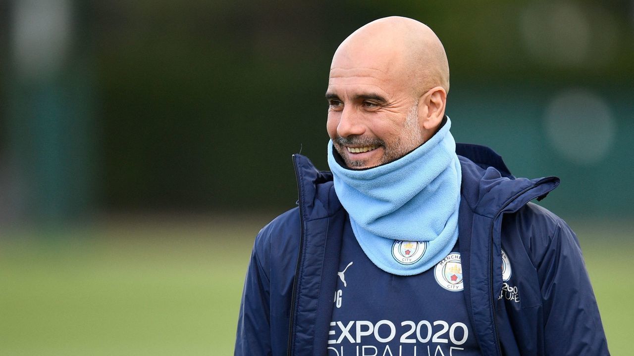Manchester City's Spanish manager Pep Guardiola reacts as he arrives to lead a training session at the Manchester City training ground in Manchester, north west England, on April 25, 2022, on the eve of their UEFA Champions League semi-final first leg football match against Real Madrid.