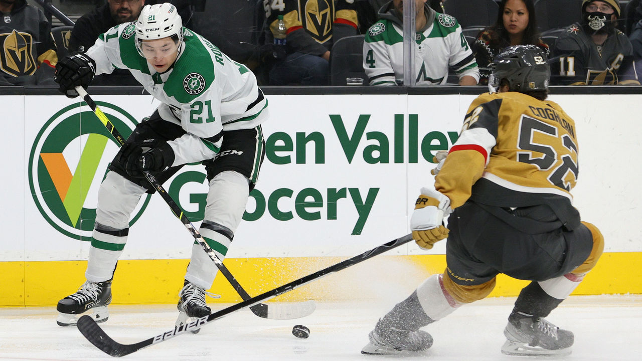 LAS VEGAS, NEVADA - DECEMBER 08: Jason Robertson #21 of the Dallas Stars controls the puck against Dylan Coghlan #52 of the Vegas Golden Knights in the third period of their game at T-Mobile Arena on December 8, 2021 in Las Vegas, Nevada. The Golden Knights defeated the Stars 5-4.