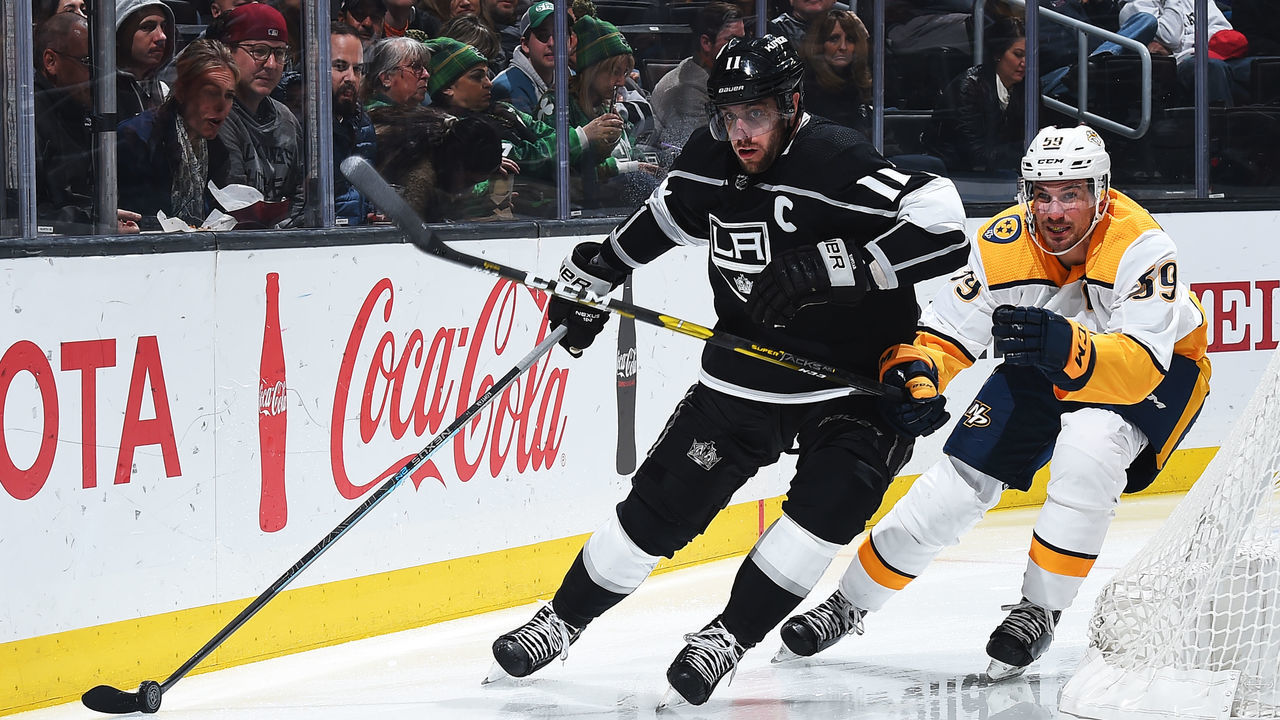 LOS ANGELES, CA - MARCH 14: Anze Kopitar #11 of the Los Angeles Kings skates with the puck with pressure from Roman Josi #59 of the Nashville Predators during the third period of the game at STAPLES Center on March 14, 2019 in Los Angeles, California.