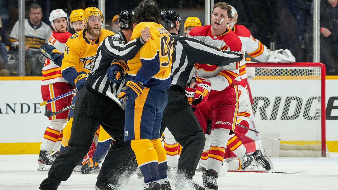 NASHVILLE, TN - APRIL 26: Linesmen separate Matt Duchene #95 of the Nashville Predators and Matthew Tkachuk #19 of the Calgary Flames during an NHL game at Bridgestone Arena on April 26, 2022 in Nashville, Tennessee.