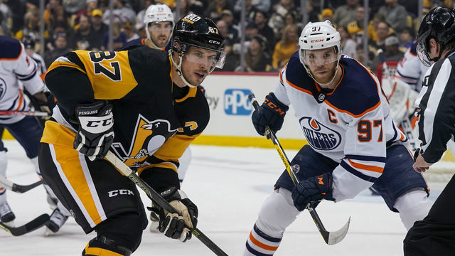 PITTSBURGH, PA - APRIL 26: Pittsburgh Penguins Center Sidney Crosby (87) and Edmonton Oilers Center Connor McDavid (97) face-off during the first period in the NHL game between the Pittsburgh Penguins and the Edmonton Oilers on April 26, 2022, at PPG Paints Arena in Pittsburgh, PA.