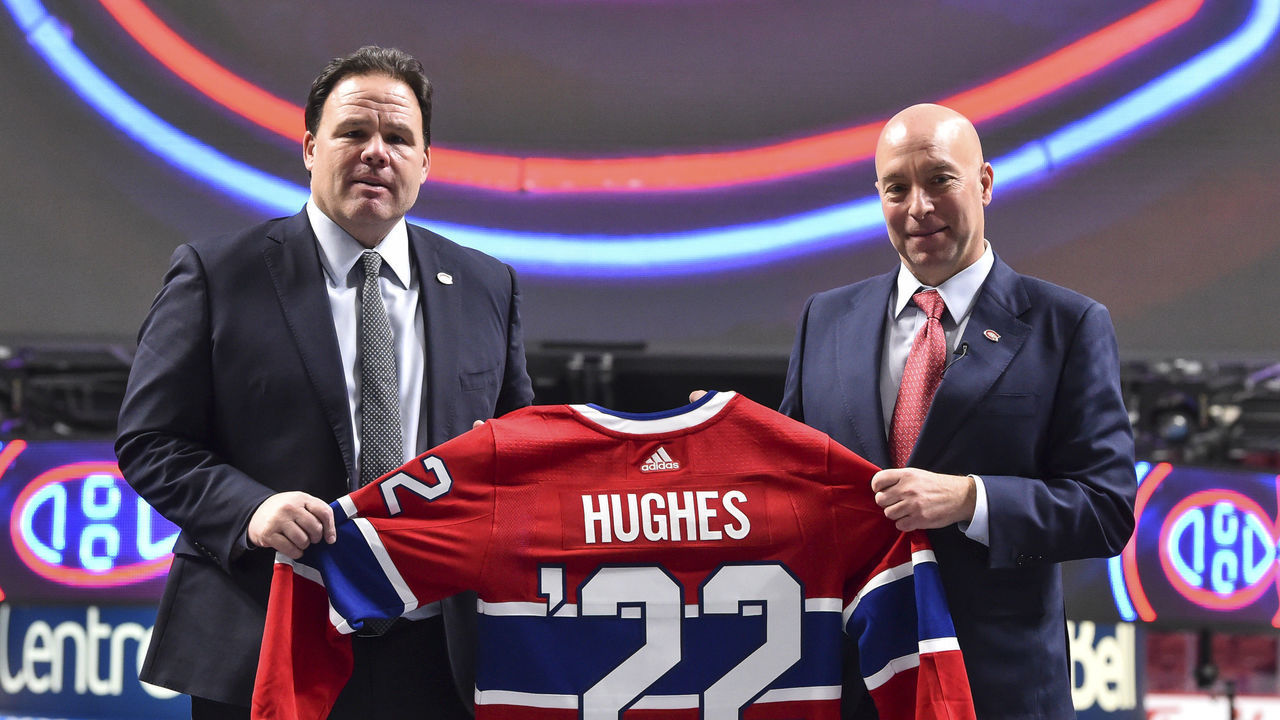 MONTREAL, QC - JANUARY 19: Executive vice president of hockey operations for the Montreal Canadiens, Jeff Gorton (L) and newly appointed general Manager of the Montreal Canadiens Kent Hughes, hold up a Canadiens' jersey during a press conference at Centre Bell on January 19, 2022 in Montreal, Canada. Kent Hughes becomes the 18th general manager in franchise history.