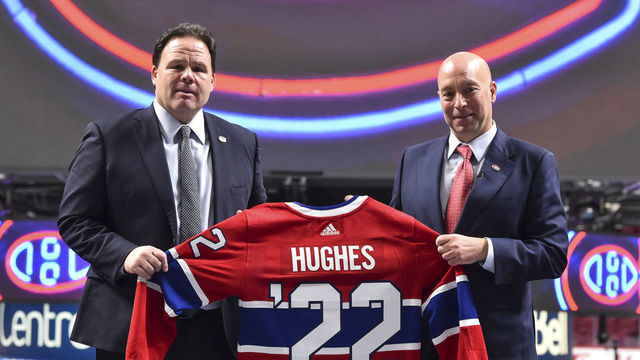 MONTREAL, QC - JANUARY 19: Executive vice president of hockey operations for the Montreal Canadiens, Jeff Gorton (L) and newly appointed general Manager of the Montreal Canadiens Kent Hughes, hold up a Canadiens' jersey during a press conference at Centre Bell on January 19, 2022 in Montreal, Canada. Kent Hughes becomes the 18th general manager in franchise history.
