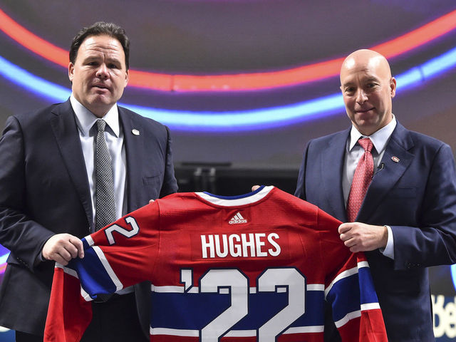 MONTREAL, QC - JANUARY 19: Executive vice president of hockey operations for the Montreal Canadiens, Jeff Gorton (L) and newly appointed general Manager of the Montreal Canadiens Kent Hughes, hold up a Canadiens' jersey during a press conference at Centre Bell on January 19, 2022 in Montreal, Canada. Kent Hughes becomes the 18th general manager in franchise history.