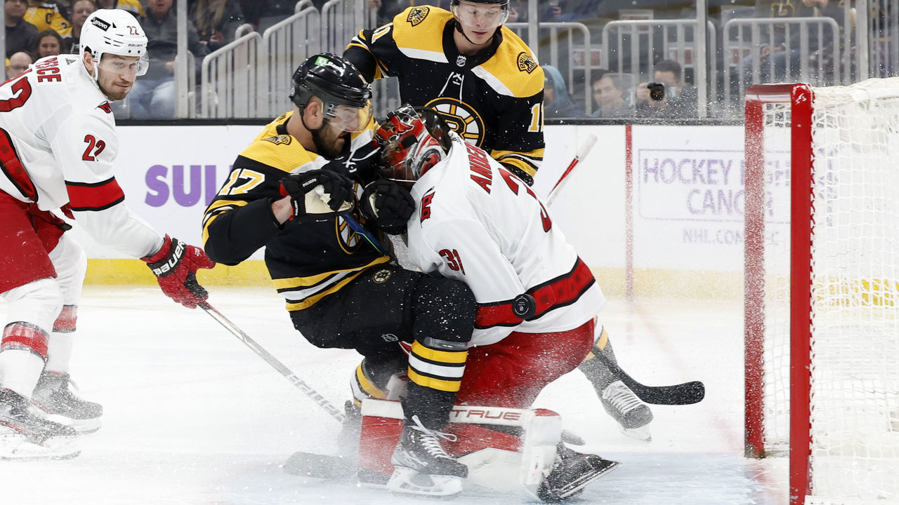 BOSTON, MA - FEBRUARY 10: Boston Bruins winger Nick Foligno (17) crashes into Carolina Hurricanes goalie Frederik Andersen (31) during a game between the Boston Bruins and the Carolina Hurricanes on February 10, 2022 at TD garden in Boston, Massachusetts.