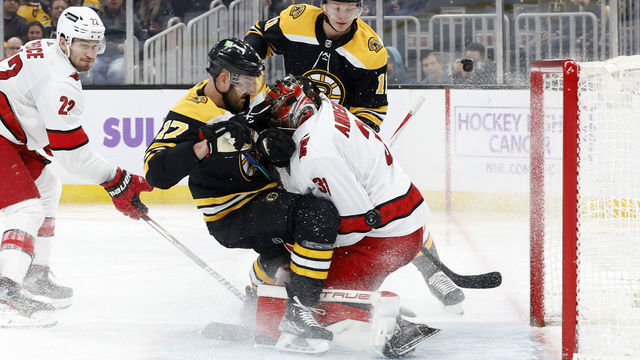 BOSTON, MA - FEBRUARY 10: Boston Bruins winger Nick Foligno (17) crashes into Carolina Hurricanes goalie Frederik Andersen (31) during a game between the Boston Bruins and the Carolina Hurricanes on February 10, 2022 at TD garden in Boston, Massachusetts.