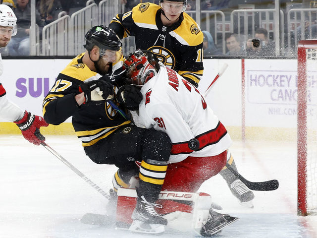 BOSTON, MA - FEBRUARY 10: Boston Bruins winger Nick Foligno (17) crashes into Carolina Hurricanes goalie Frederik Andersen (31) during a game between the Boston Bruins and the Carolina Hurricanes on February 10, 2022 at TD garden in Boston, Massachusetts.