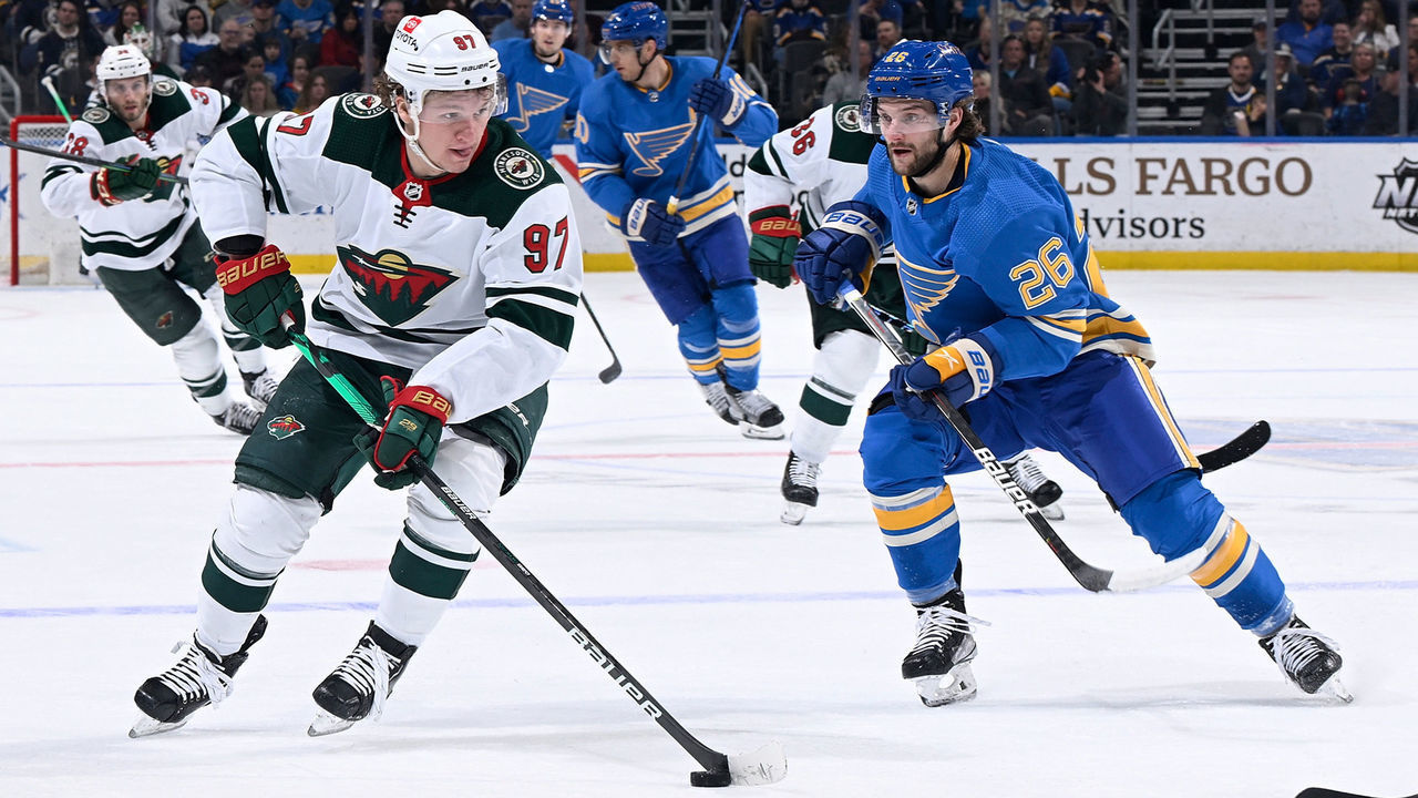 ST. LOUIS, MO - APRIL 16: Nathan Walker #26 of the St. Louis Blues pressures Kirill Kaprizov #97 of the Minnesota Wild at the Enterprise Center on April 16, 2022 in St. Louis, Missouri.