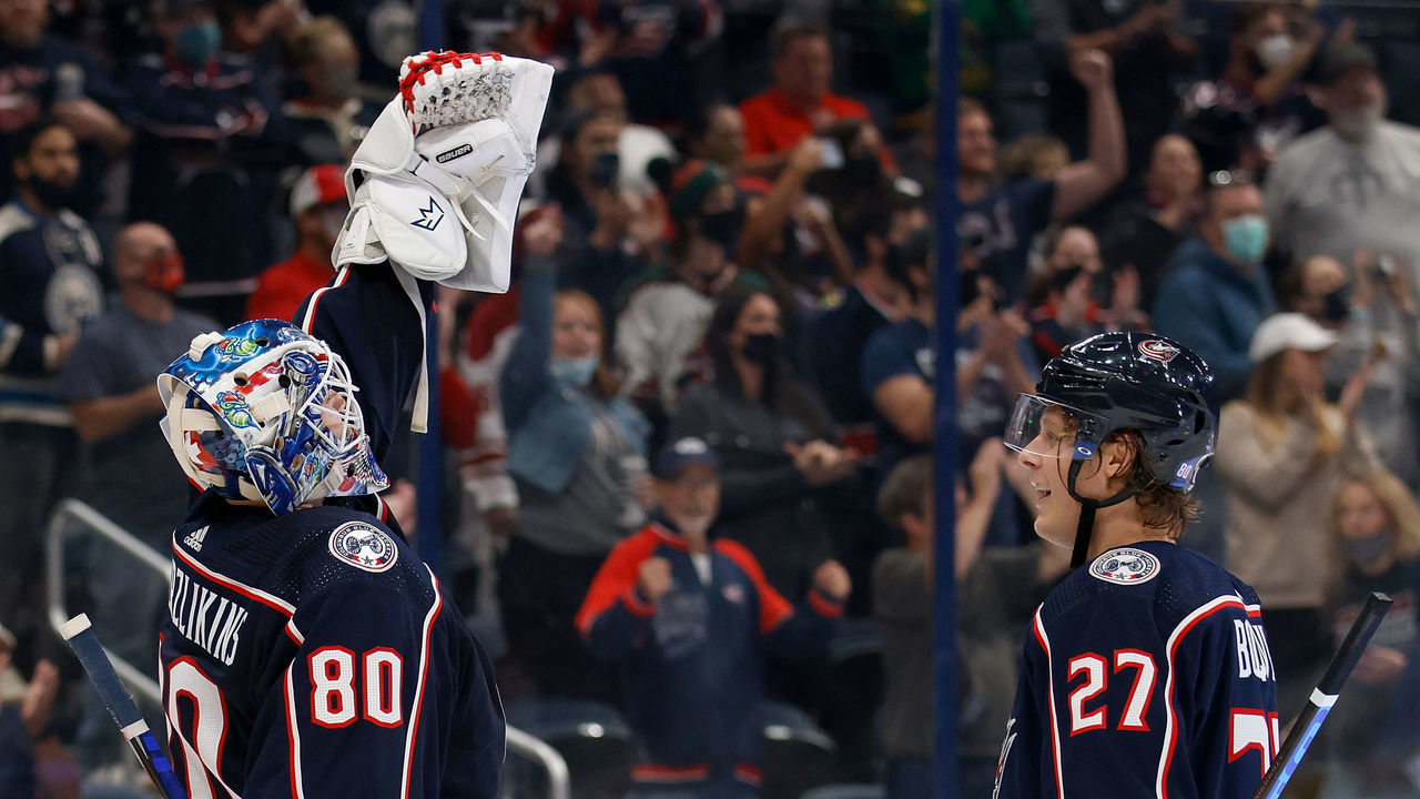 COLUMBUS, OH - OCTOBER 14: Adam Boqvist #27 of the Columbus Blue Jackets waits to congratulate Elvis Merzlikins #80 as he reacts after defeating the Arizona Coyotes 8-2 at Nationwide Arena on October 14, 2021 in Columbus, Ohio. Merzlikins was wearing #80 in honor of Matiss Kivlenieks who passed away last summer.
