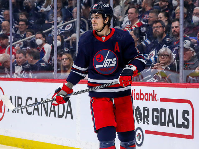 WINNIPEG, MB - APRIL 06: Mark Scheifele #55 of the Winnipeg Jets keeps an eye on the play during third period action against the Detroit Red Wings at Canada Life Centre on April 06, 2022 in Winnipeg, Manitoba, Canada.