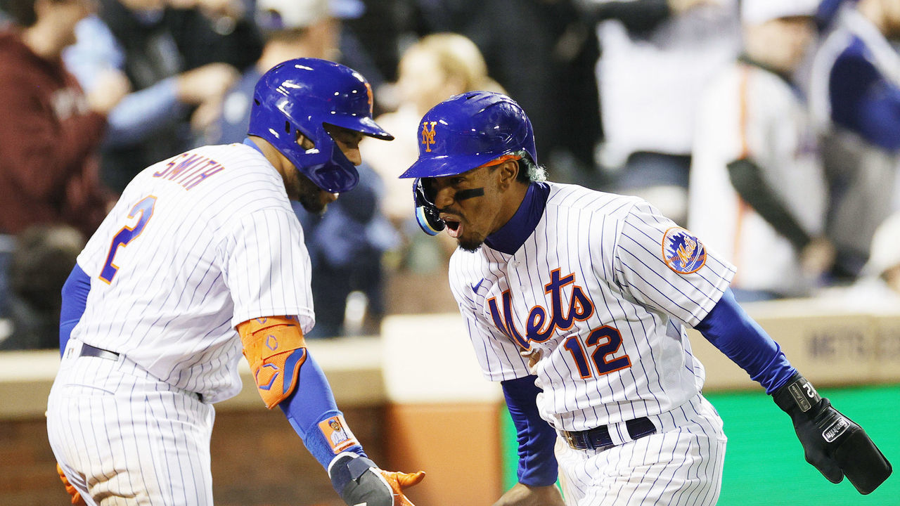 NEW YORK, NEW YORK - MAY 01: Francisco Lindor #12 reacts with Dominic Smith #2 of the New York Mets after scoring on a wild pitch during the fifth inning against the Philadelphia Phillies at Citi Field on May 01, 2022 in the Queens borough of New York City.