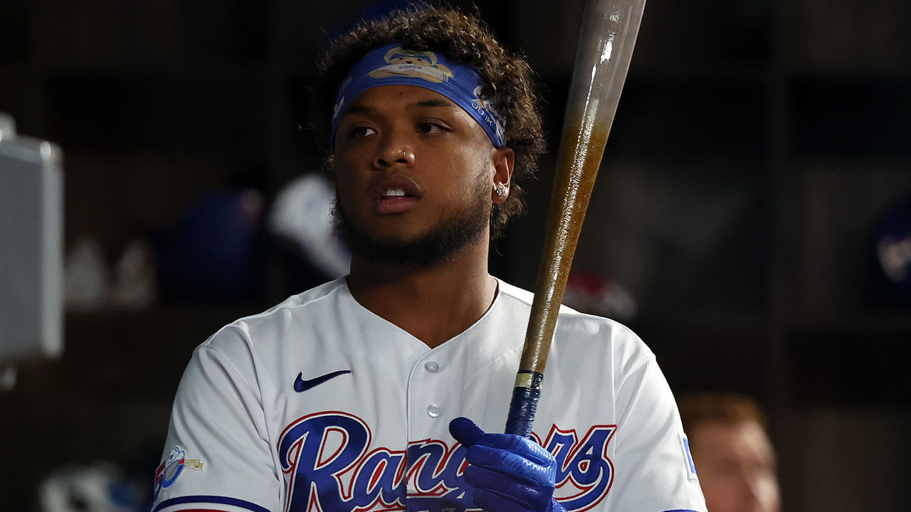 ARLINGTON, TEXAS - APRIL 25: Willie Calhoun #4 of the Texas Rangers stands in the dugout during a game against the Houston Astros at Globe Life Field on April 25, 2022 in Arlington, Texas.