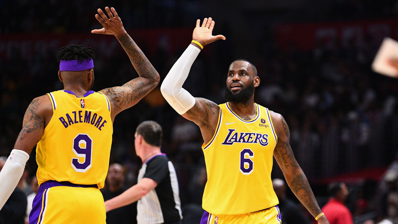 LOS ANGELES, CA - MARCH 03: Los Angeles Lakers Forward Kent Bazemore (9) celebrates with Los Angeles Lakers Forward LeBron James (6) during a NBA game between the Los Angeles Lakers and the Los Angeles Clippers on March 3, 2022 at Crypto.com Arena in Los Angeles, CA.