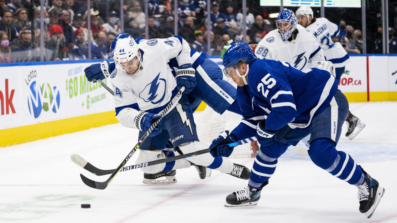 TORONTO, ON - DECEMBER 9: Jan Rutta #44 of the Tampa Bay Lightning battles for the puck against Ondrej Kase #25 of the Toronto Maple Leafs during the first period at the Scotiabank Arena on December 9, 2021 in Toronto, Ontario, Canada.