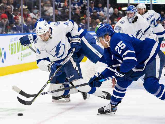 TORONTO, ON - DECEMBER 9: Jan Rutta #44 of the Tampa Bay Lightning battles for the puck against Ondrej Kase #25 of the Toronto Maple Leafs during the first period at the Scotiabank Arena on December 9, 2021 in Toronto, Ontario, Canada.