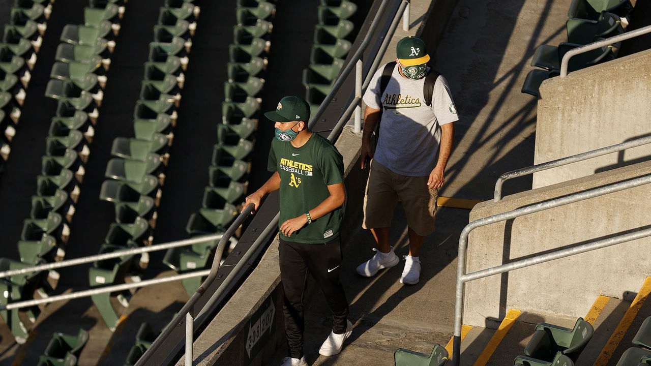 OAKLAND, CALIFORNIA - APRIL 01: Oakland Athletics fans walk to their seats for their Opening Day game against the Houston Astros at RingCentral Coliseum on April 01, 2021 in Oakland, California.