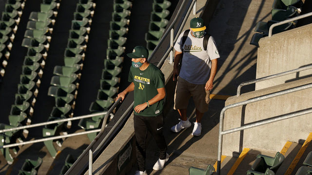 OAKLAND, CALIFORNIA - APRIL 01: Oakland Athletics fans walk to their seats for their Opening Day game against the Houston Astros at RingCentral Coliseum on April 01, 2021 in Oakland, California.