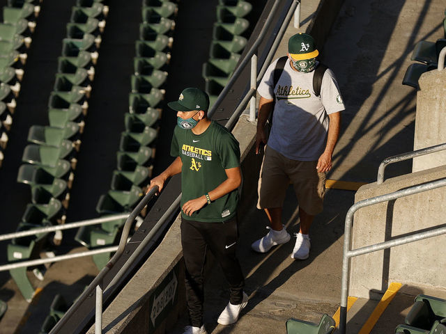 OAKLAND, CALIFORNIA - APRIL 01: Oakland Athletics fans walk to their seats for their Opening Day game against the Houston Astros at RingCentral Coliseum on April 01, 2021 in Oakland, California.