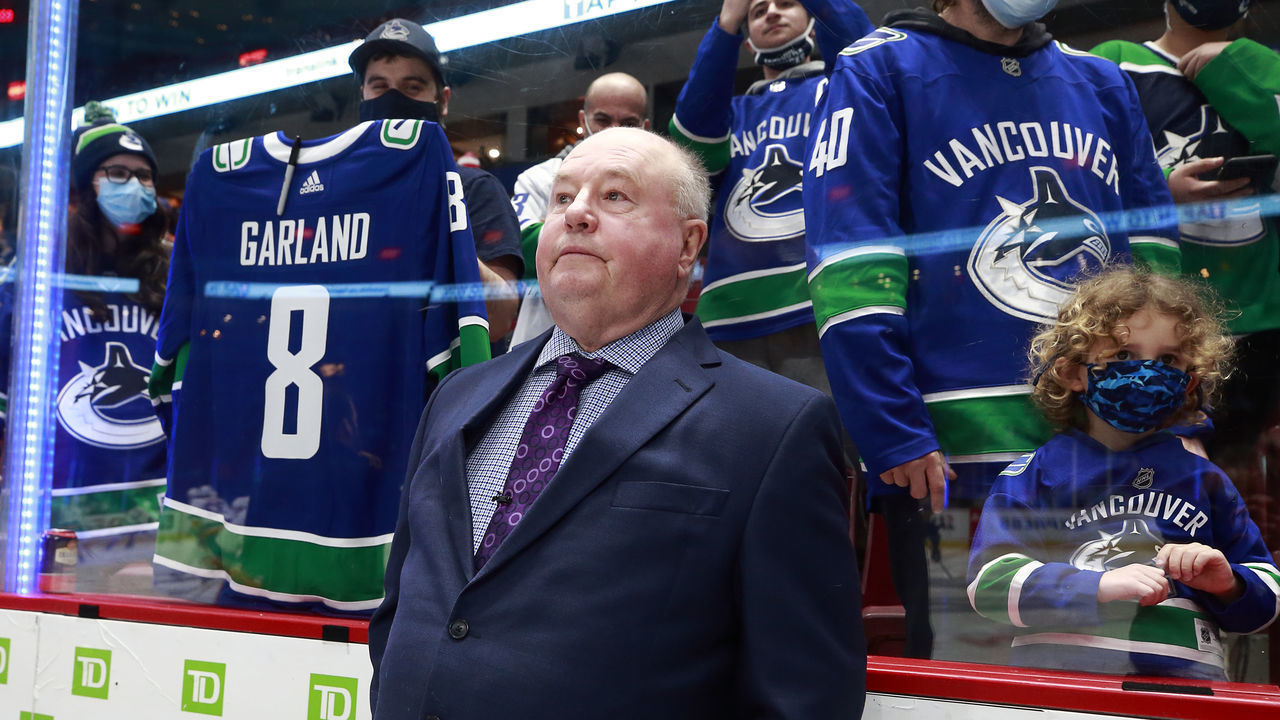 VANCOUVER, BC - FEBRUARY 09: Head coach Bruce Boudreau of the Vancouver Canucks looks on from the bench before an NHL game against the New York Islanders at Rogers Arena on February 9, 2022 in Vancouver, British Columbia, Canada.