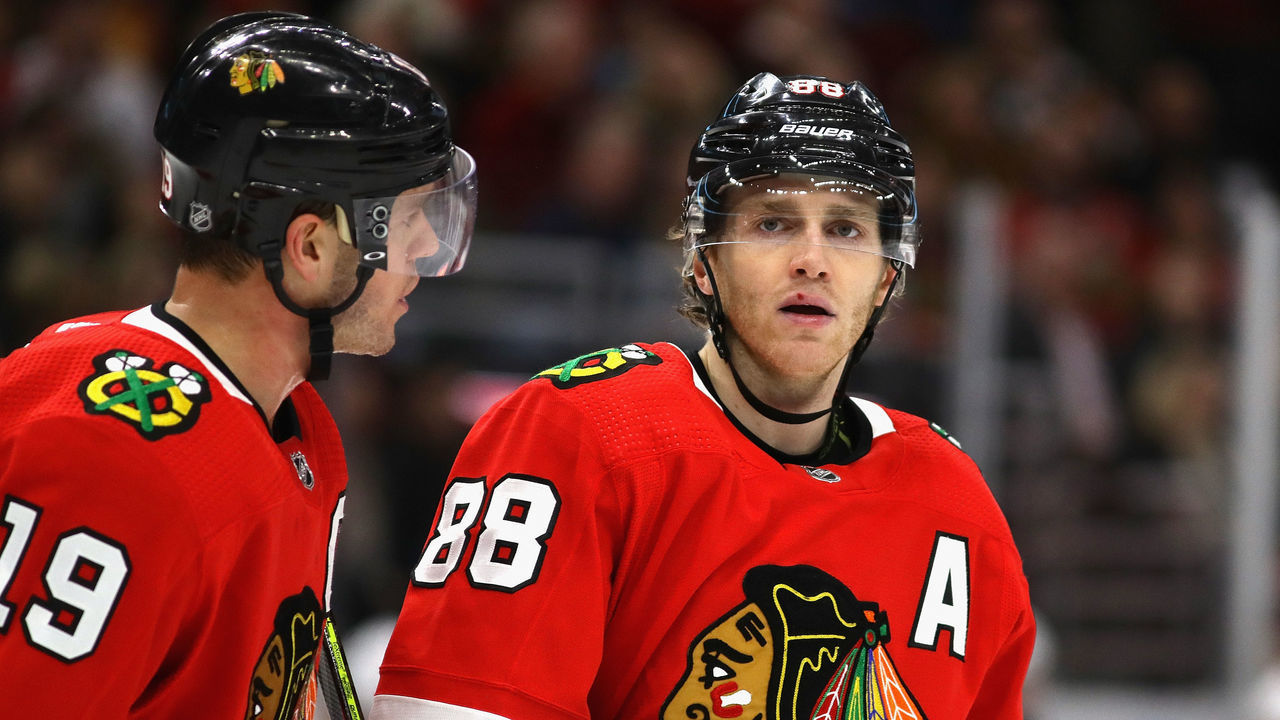 CHICAGO, ILLINOIS - DECEMBER 27: Jonathan Toews #19 of the Chicago Blackhawks talks with Patrick Kane #88 before a face-off against the New York Islanders at the United Center on December 27, 2019 in Chicago, Illinois. The Blackhawks defeated the Islanders 5-2.