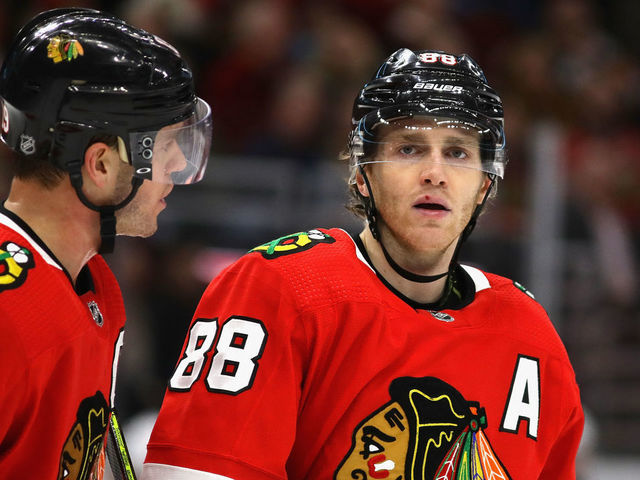 CHICAGO, ILLINOIS - DECEMBER 27: Jonathan Toews #19 of the Chicago Blackhawks talks with Patrick Kane #88 before a face-off against the New York Islanders at the United Center on December 27, 2019 in Chicago, Illinois. The Blackhawks defeated the Islanders 5-2.